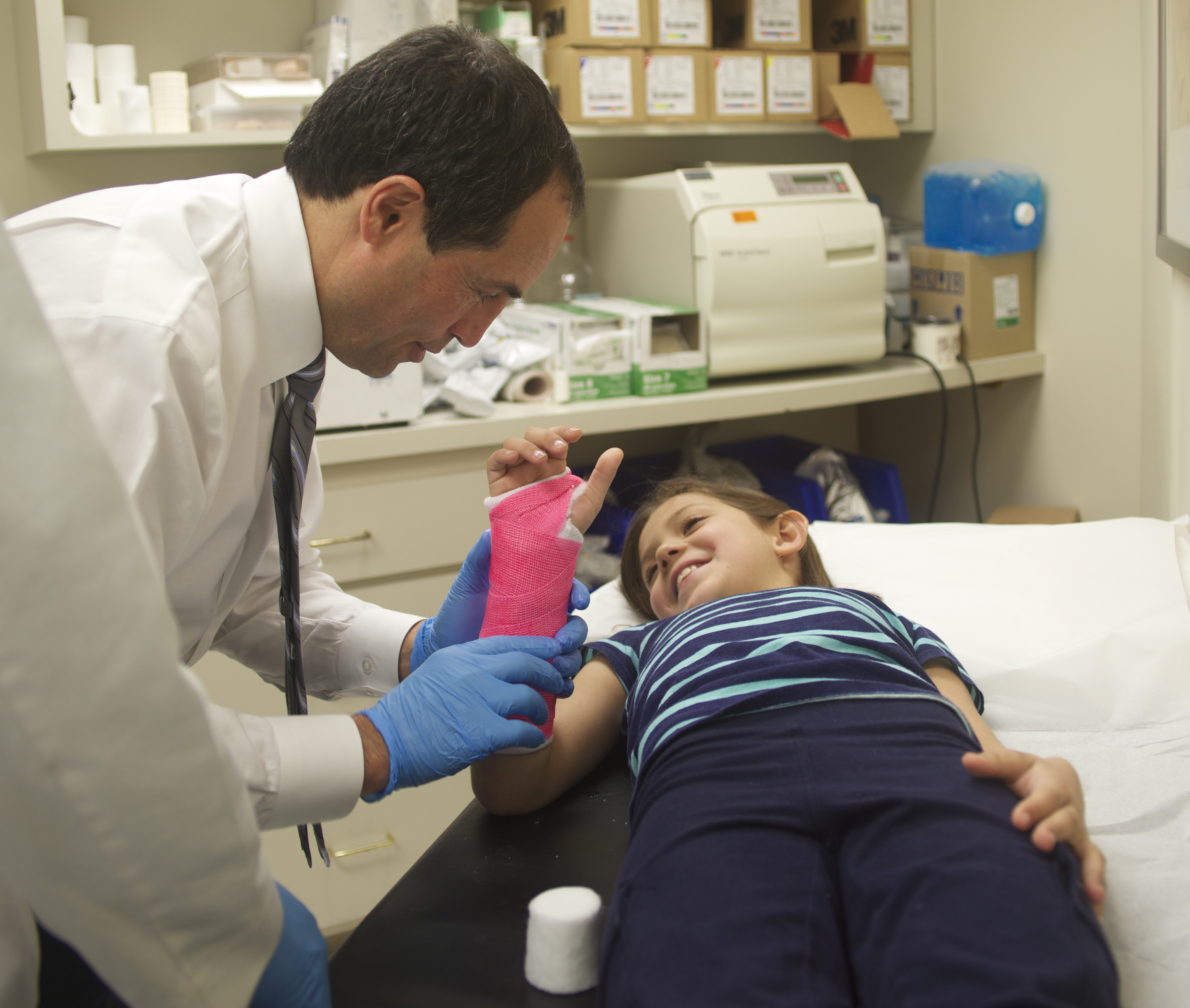 Dr. Romano examining a patient.